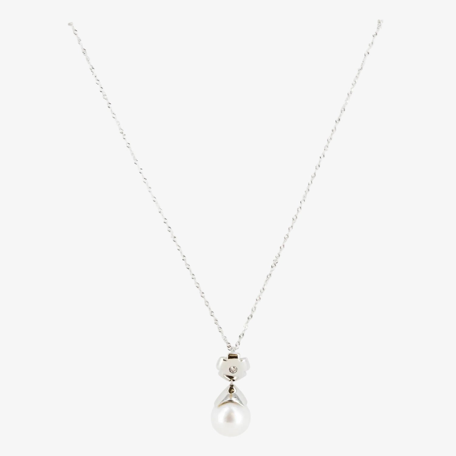 Colgante de oro blanco de 18 kt. con perla australiana de 12 mm. y diamante talla brillante