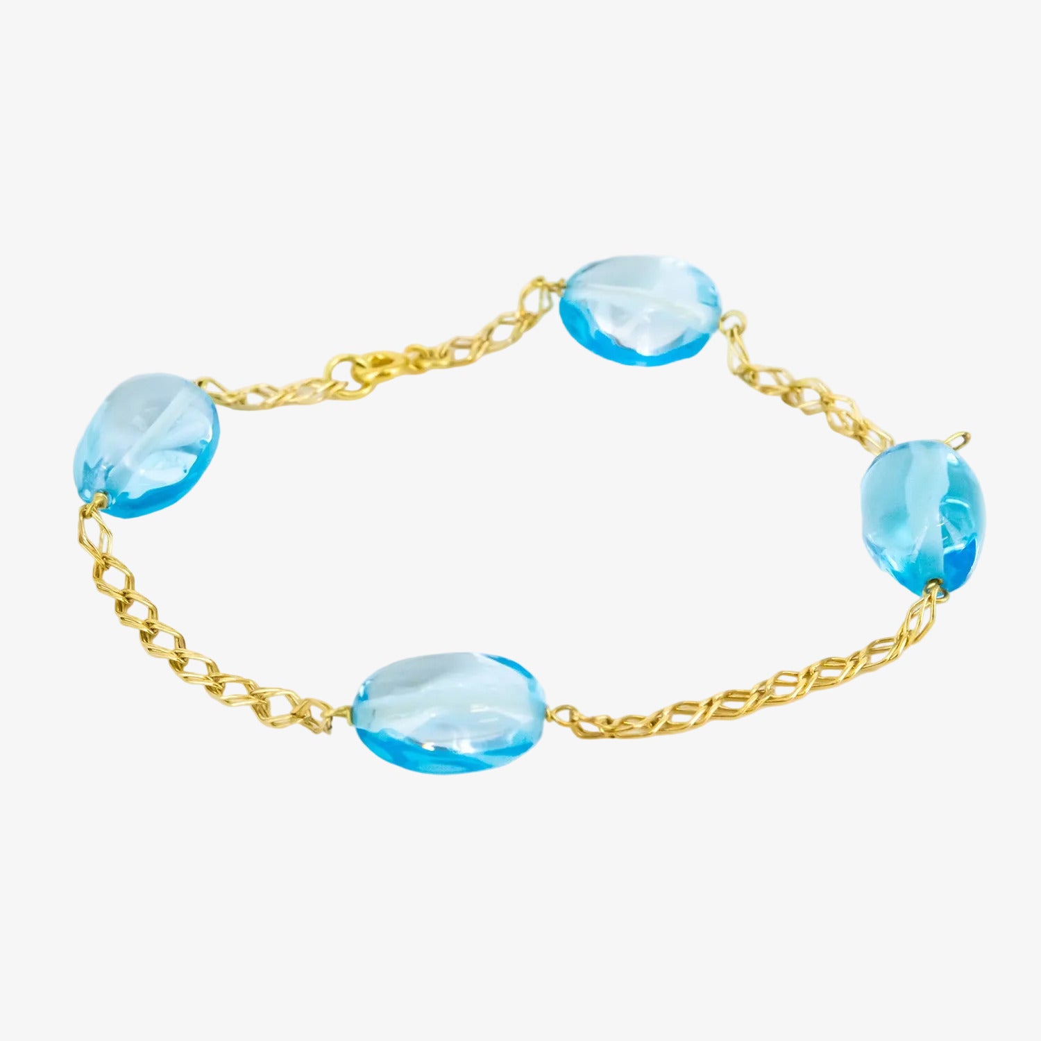 Pulsera de oro de 18 kt. con topacios azules ovalados