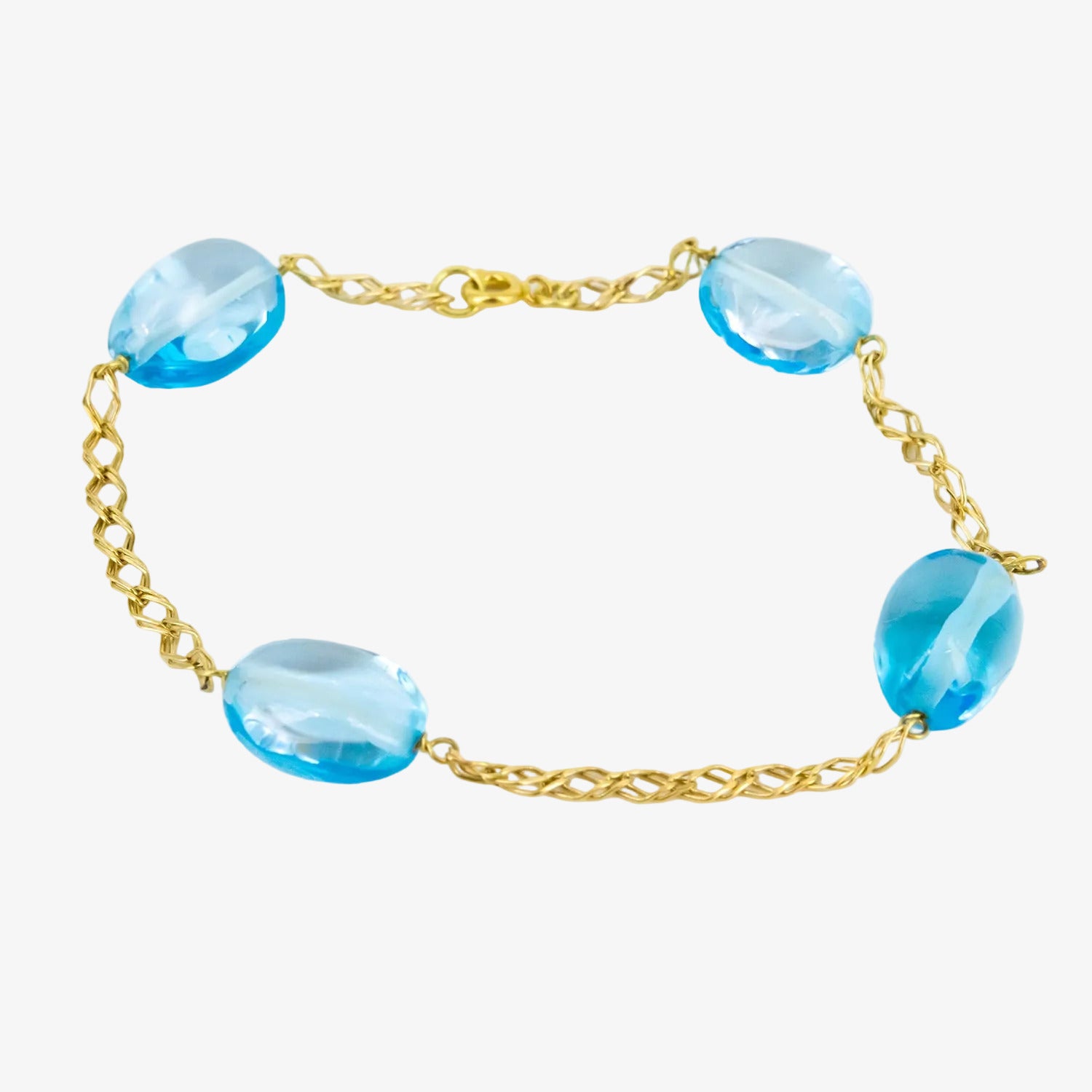 Pulsera de oro de 18 kt. con topacios azules ovalados