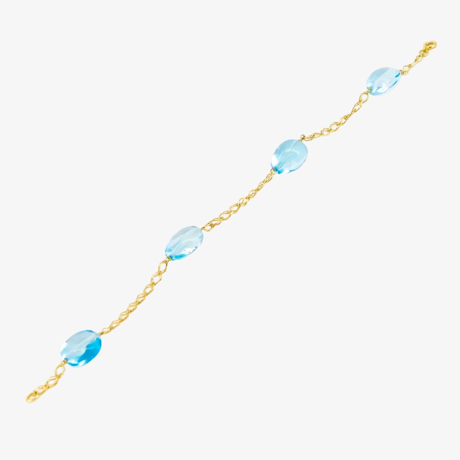 Pulsera de oro de 18 kt. con topacios azules ovalados