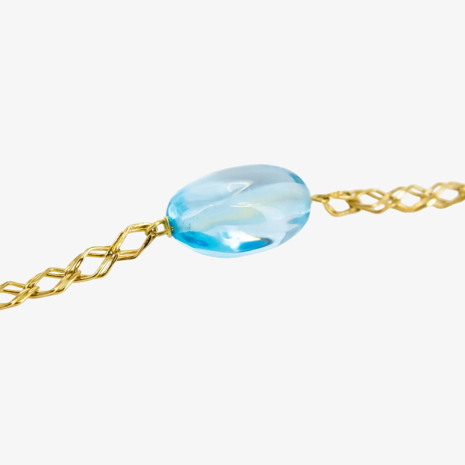 Pulsera de oro de 18 kt. con topacios azules ovalados