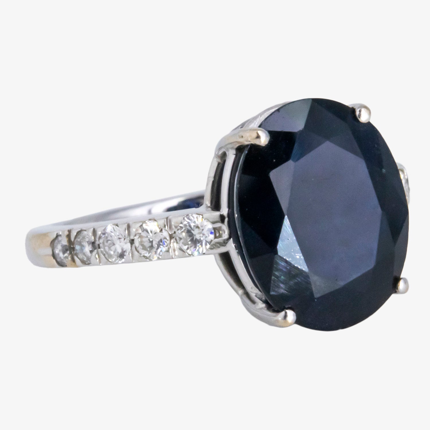 Sortija de oro blanco 18 kt. con zafiro de talla oval y diamantes talla brillante