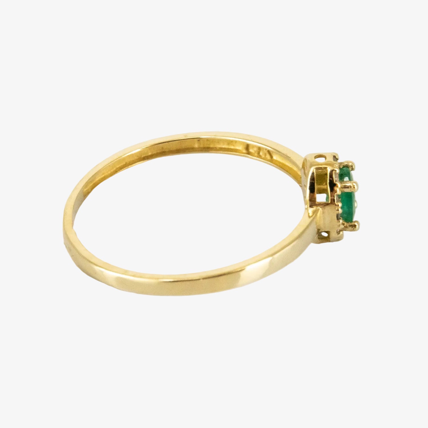 Sortija de oro amarillo de 14 kt. con doce diamantes y una esmeralda de 0.30 ct.