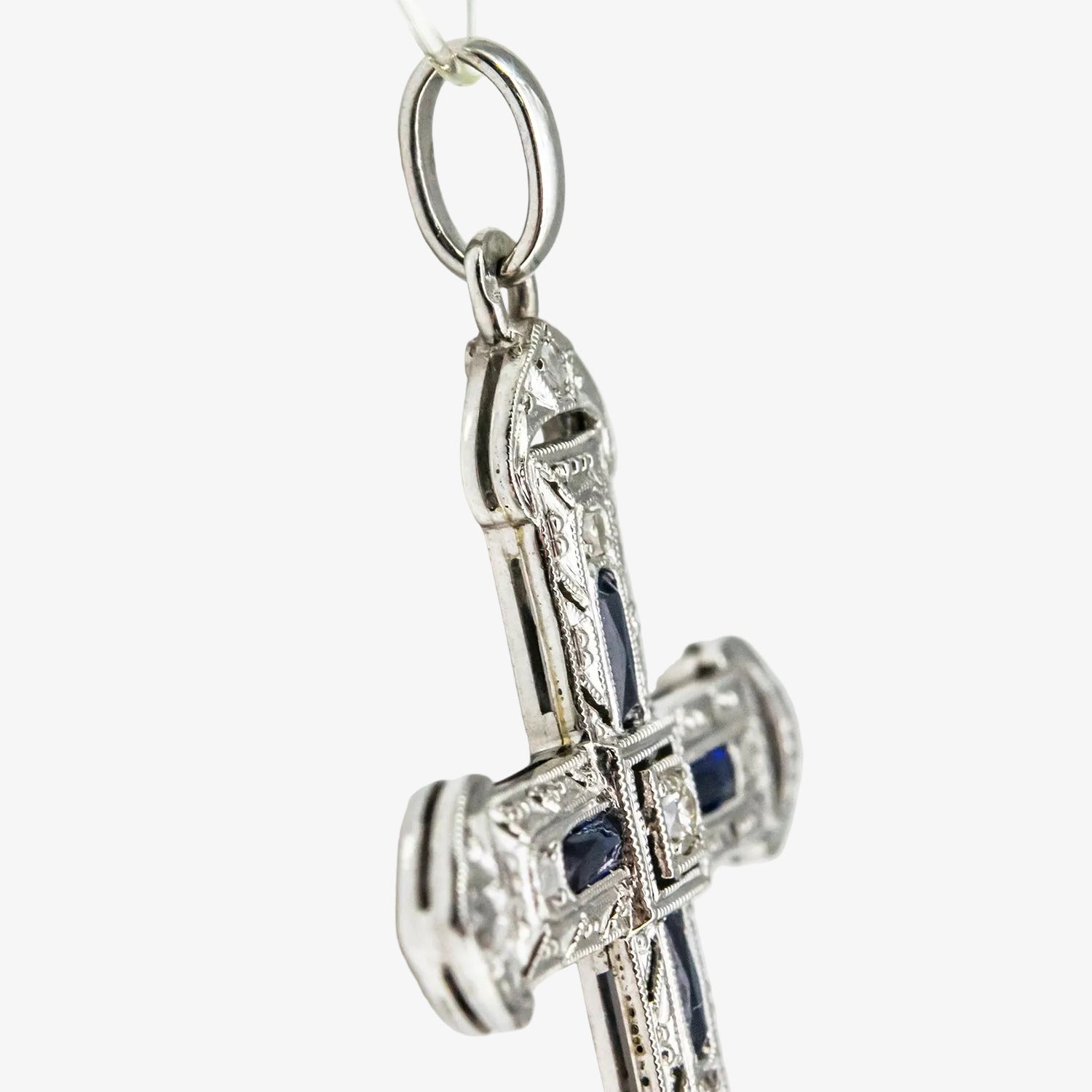 Colgante cruz de oro blanco 18 kt. con diamantes y zafiros